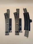 3 Ho Train Tracks (2)ATLAS Snap Switch Left, (1)BACHMANN 8 Terminal Rerailer. Fixed Price $19.97.