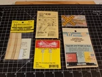 Assorted SET/5 Grade Crossings (2), Crossbucks, Air Hose, Coupler Pk (011517). Fixed Price $11.99.